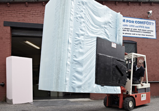 Taking delivery of a large block of foam using a fork lift truck